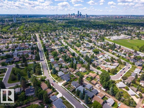 Expansive aerial perspective showcasing a residential neighborhood with mature trees - 6916 92A Avenue, Edmonton, AB 