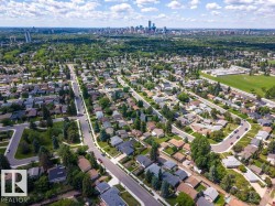 Expansive aerial perspective showcasing a residential neighborhood with mature trees - 