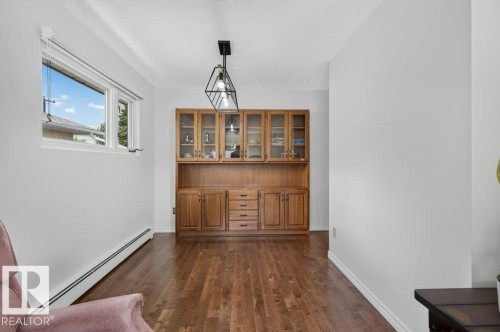 Built-in wood cabinetry with glass-front uppers and drawer storage - 6916 92A Avenue, Edmonton, AB 
