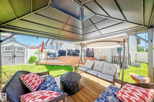 Multi-level wood deck with a built-in metal gazebo, a separate storage shed, and a privacy fence - 12410 171A Avenue, Edmonton, AB 