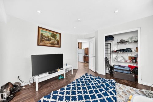 Spacious room featuring recessed lighting, wood-finish flooring, and a large open closet with wire shelving - 12410 171A Avenue, Edmonton, AB 