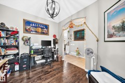 Interior room featuring dark wood-finish flooring and light-toned walls - 