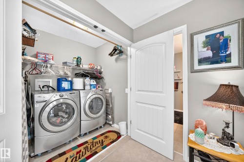 Dedicated laundry area featuring wire shelving, overhead storage, and tile flooring - 12410 171A Avenue, Edmonton, AB 