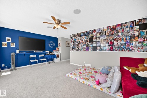 Spacious room with light gray carpeting, a ceiling fan with integrated lighting, and recessed ceiling speakers - 12410 171A Avenue, Edmonton, AB 