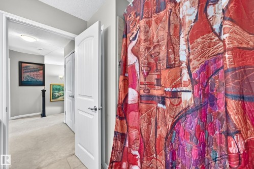 Hallway featuring neutral carpeting and light gray wall paint - 12410 171A Avenue, Edmonton, AB 