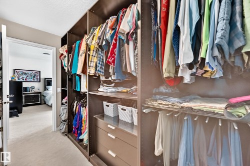 Integrated closet system featuring multiple hanging rods, shelving, and built-in drawers - 12410 171A Avenue, Edmonton, AB 