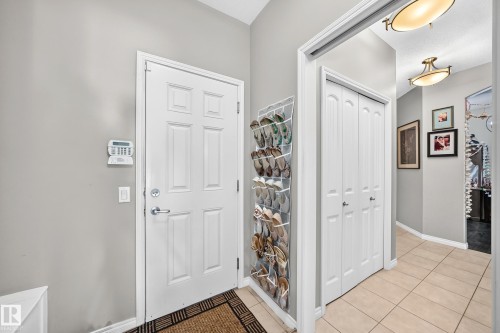 Entryway featuring a white paneled door, light gray walls, and light tile flooring - 12410 171A Avenue, Edmonton, AB 