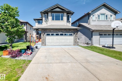 Modern two-story residence featuring light-toned siding and a stone facade on the lower level - 12410 171A Avenue, Edmonton, AB 