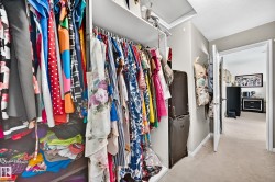 Built-in closet system with shelving and hanging rods - 