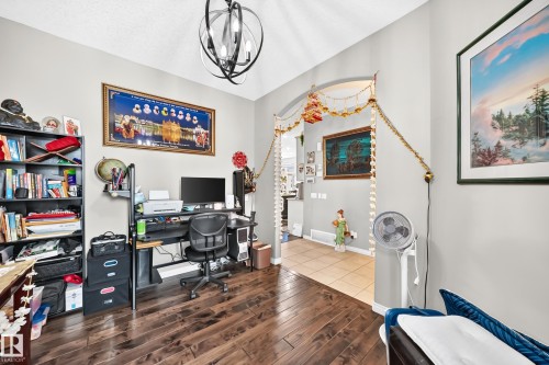 Interior room featuring dark wood-finish flooring and light-toned walls - 12410 171A Avenue, Edmonton, AB 