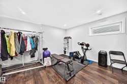 Versatile room featuring wood-finish flooring and recessed lighting - 