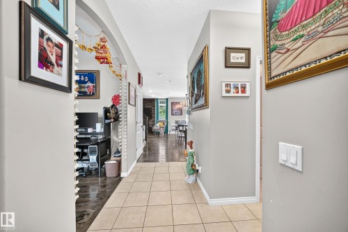 Tiled entryway with light gray walls, white baseboards, and a decorative archway - 12410 171A Avenue, Edmonton, AB 