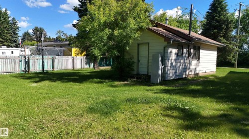 Detached white-sided outbuilding with a brown-shingled roof - 5416 51 Avenue, Andrew, AB 