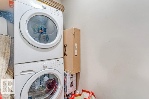 White stacked laundry appliances - 225 111 Watt Common, Edmonton, AB 