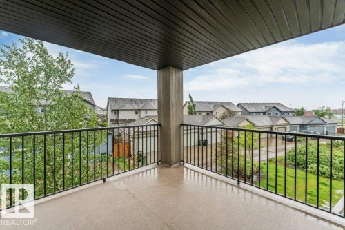 Private balcony with concrete flooring, black metal railings, and a solid overhead covering - 225 111 Watt Common, Edmonton, AB 
