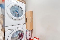 Stacked white front-load washer and dryer units - 