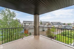 Private balcony featuring a concrete floor and black metal railings - 