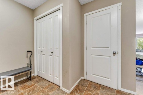 Neutral-toned walls complement the brown-hued tile flooring - 225 111 Watt Common, Edmonton, AB 