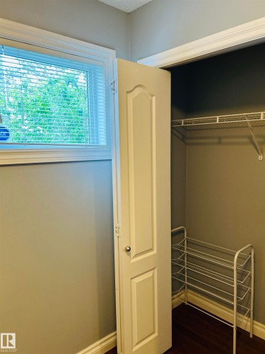 White paneled door opening to a closet featuring wire shelving - 89 12050 17 Avenue, Edmonton, AB 