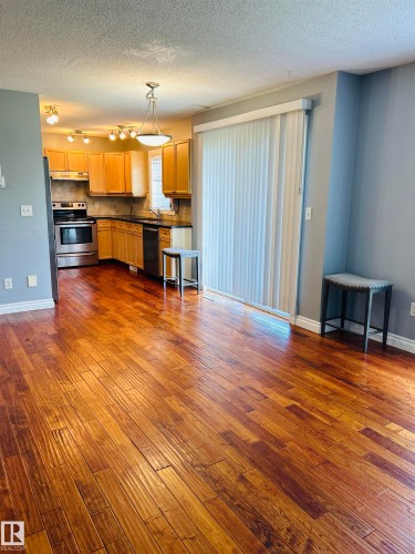 Hardwood-finish flooring extending into the kitchen - 89 12050 17 Avenue, Edmonton, AB 