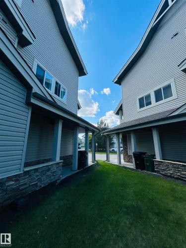 Siding exterior with stone accents and covered entryways - 89 12050 17 Avenue, Edmonton, AB 