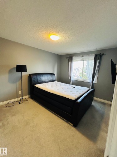 Neutral gray wall paint, off-white trim, and light-colored carpeting - 89 12050 17 Avenue, Edmonton, AB 