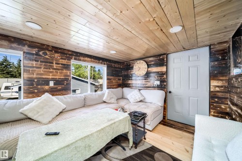 Interior space featuring wood-finish wall paneling, a wood-finish plank ceiling, and wood-finish flooring - 14808 96 Street, Edmonton, AB 