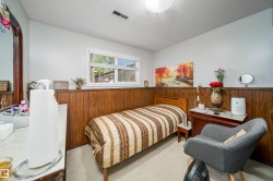 Room featuring light wall paint and lower wood paneling - 