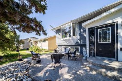 Front exterior with dark grey siding and white trim - 