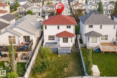 White exterior with a red shingle roof - 1906 37B Av, Edmonton, AB 