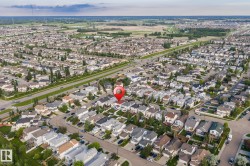 Aerial perspective highlighting a suburban neighborhood characterized by uniform residential structures - 