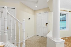 Entryway featuring a paneled door with brass hardware, tile flooring, and a recessed ceiling light - 