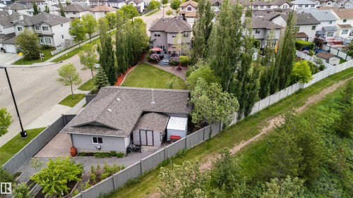 Aerial perspective featuring a property with a grey exterior, dark shingle roof, and a paved driveway - 704 Wildwood Point(E), Edmonton, AB 