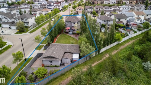 Expansive property featuring two distinct structures, a spacious main residence with a large backyard patio, and a separate single-story building with its own fenced area - 704 Wildwood Point(E), Edmonton, AB 