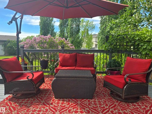 Spacious outdoor deck featuring dark composite decking and a black railing system - 704 Wildwood Point(E), Edmonton, AB 