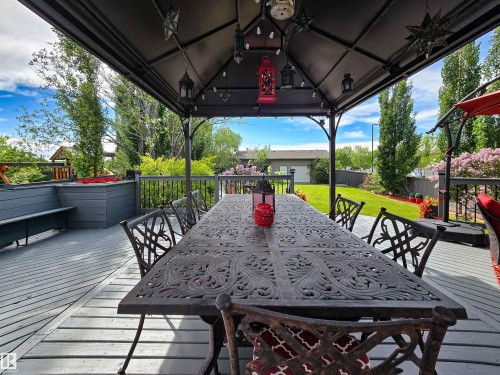 Spacious outdoor deck featuring a dark metal gazebo, built-in planter boxes, and a built-in bench seating area - 704 Wildwood Point(E), Edmonton, AB 