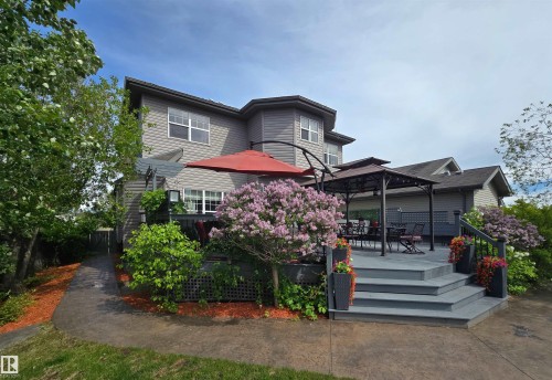 Multi-level deck featuring composite decking, integrated steps, and privacy lattice - 704 Wildwood Point(E), Edmonton, AB 