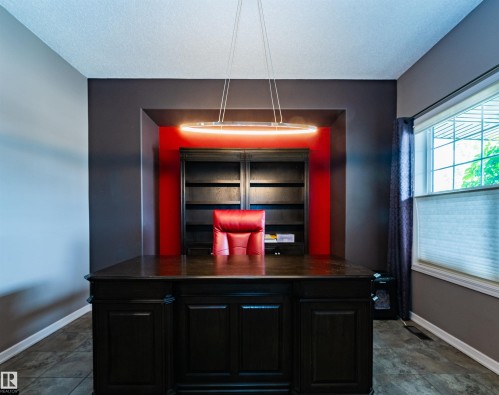 Dedicated office space featuring built-in shelving, tile flooring, and a window with blinds - 704 Wildwood Point(E), Edmonton, AB 
