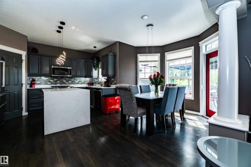 Contemporary kitchen and dining area featuring dark wood-finish flooring - 704 Wildwood Point(E), Edmonton, AB 