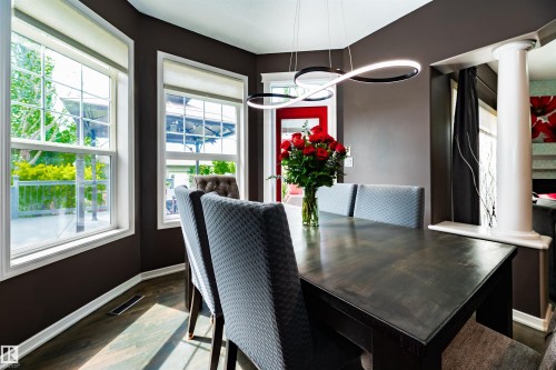 Dining area featuring dark wood-finish flooring and deep-toned walls - 704 Wildwood Point(E), Edmonton, AB 