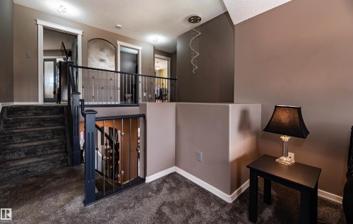 Multi-level interior featuring a carpeted staircase and landing - 704 Wildwood Point(E), Edmonton, AB 