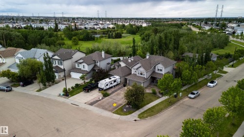 Suburban residence featuring a two-story design with light gray siding and a dark shingle roof - 704 Wildwood Point(E), Edmonton, AB 