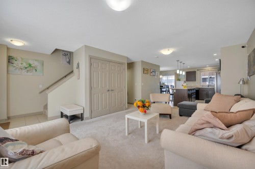 Bright living space featuring neutral carpet flooring and light-toned walls - 29 1150 Windermere Way, Edmonton, AB 