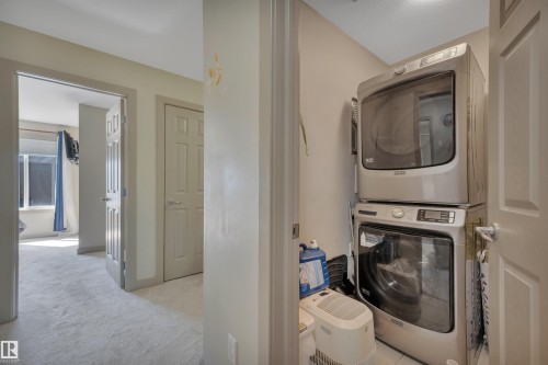 Dedicated laundry closet featuring a stacked washer and dryer - 29 1150 Windermere Way, Edmonton, AB 