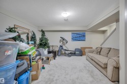 Spacious room featuring light-toned walls, textured ceiling, recessed lighting, and soft grey carpeting throughout - 