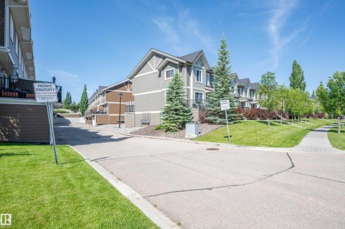 Exterior of multi-level townhomes with gabled roofs and siding finishes - 29 1150 Windermere Way, Edmonton, AB 