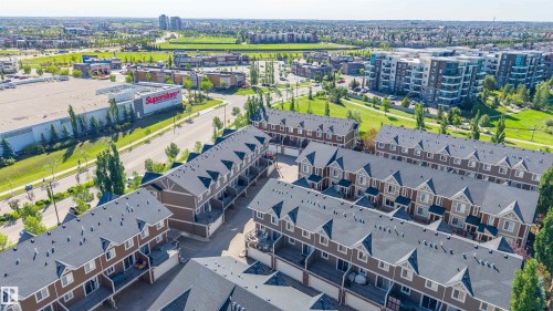Aerial perspective showcasing multiple rows of multi-story townhomes with dormer windows and rear-facing balconies - 29 1150 Windermere Way, Edmonton, AB 