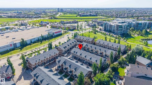 Townhome community with brown siding and dark-pitched roofs - 29 1150 Windermere Way, Edmonton, AB 