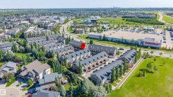 Aerial perspective showcasing a residential development with multiple townhome-style units - 
