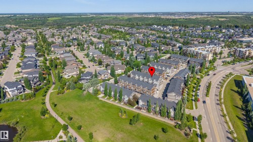 Aerial perspective of a residential development featuring multiple townhome structures and single-family residences - 29 1150 Windermere Way, Edmonton, AB 
